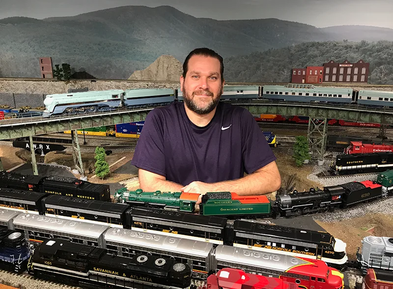 Eric Siegel with his O-scale model train layout